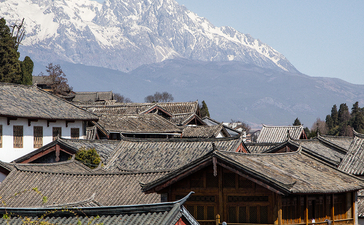 Amandayan's traditional architecture with snow-capped mountain backdrop and verdant gardens.