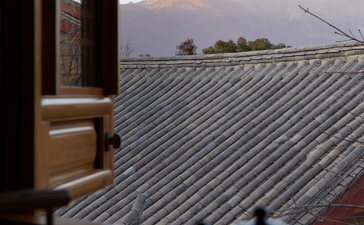 Amandayan's roofline frames a distant mountain peak under soft morning light.