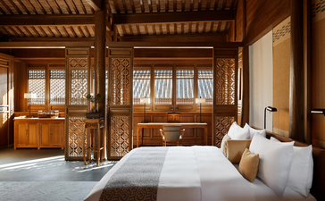Principal bedroom at Amandayan with wooden architectural details and traditional furnishings.