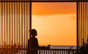 Silhouette of a person on a terrace at sunset, Amanyara resort.
