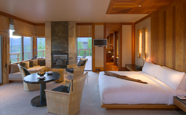 Spring Gulch Suite at Amangani with bed, seating area, and mountain views through large windows.