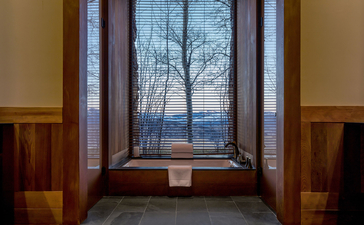 Spring Gulch Suite window at Amangani overlooking mountain vista at dusk.