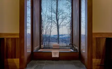 Spring Gulch Suite window at Amangani overlooking mountain vista at dusk.