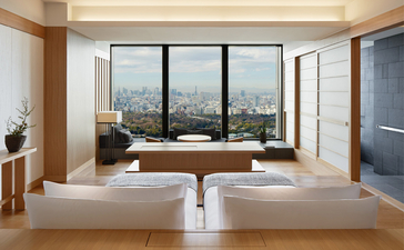 Deluxe Palace Garden View Room at Aman Tokyo hotel with panoramic city views from floor-to-ceiling windows, minimalist furnishings, and serene interior design.