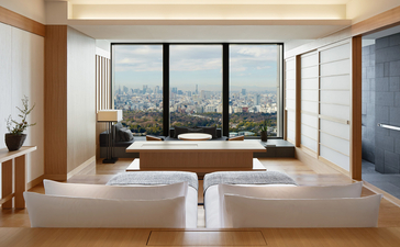 Deluxe Room at Aman Tokyo with twin beds facing expansive windows overlooking the city.