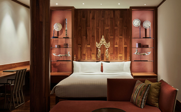 Eight-bedroom garden villa principal bedroom with teak wood panelling and altar at Amanpuri, Thailand.