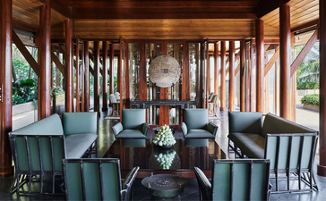 Dressing room with wooden cabinetry and striped fabric panels at Amanpuri resort, Thailand.