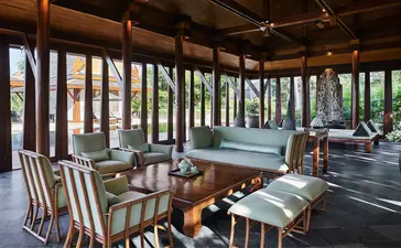 Four-bedroom villa dining pavilion with teak columns and garden views at Amanpuri, Thailand.