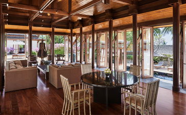 Four-bedroom garden villa dining area with wooden beams and garden views at Amanpuri, Thailand.