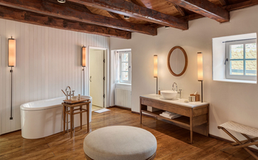 Grand Cottage principal bedroom with ensuite bathroom at Aman Sveti Stefan, Montenegro.