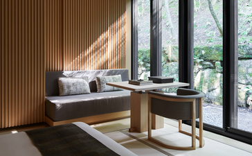 Hotaru Room at Aman Kyoto with window seat, cushions, wooden desk and garden views.