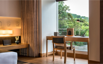 Lake Pavilion at Amanoi with dining table overlooking Vietnamese landscape.