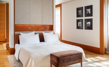Principal bedroom in the Sea View Suite at Aman Sveti Stefan, Montenegro, with terracotta wood accents and Adriatic views.