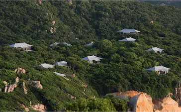 Mountain pavilions nestled amongst dense forest at Amanoi, Vietnam.
