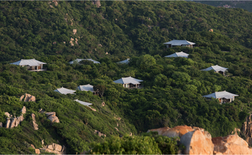 Mountain villa nestled among dense Vietnamese jungle canopy at Amanoi.