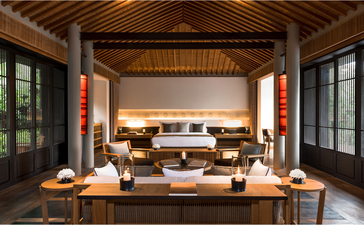Ocean Pavilion lounge at Amanoi, Vietnam, with wooden ceiling and floor-to-ceiling windows overlooking the sea.