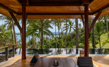 Pavilion overlooking the ocean pool at Amanpuri resort, Thailand, with timber structure and tropical views.
