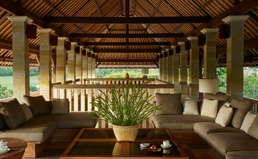 Six-bedroom villa living pavilion at Aman Villas at Nusa Dua, Bali, with wooden beams and stone seating.