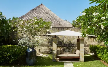 Six-bedroom villa with thatched roof and open pavilion at Aman Villas at Nusa Dua, Bali.