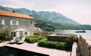 Sveti Stefan Suite terrace overlooking the Adriatic coast and mountains, Aman Sveti Stefan, Montenegro.