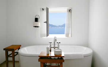Sveti Stefan Suite bathroom with dual basin vanity and framed window view of Adriatic Sea, Aman Sveti Stefan.