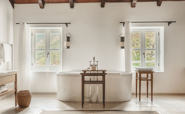 Two-bedroom suite at Aman Sveti Stefan with dual windows, neutral furnishings, and minimalist décor in Montenegro.