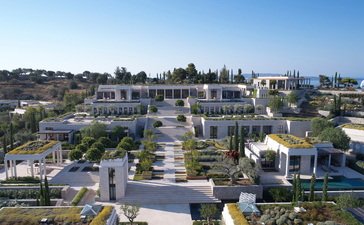 Villa 20 at Amanzoe resort, Greece, aerial view of whitewashed accommodation and grounds.