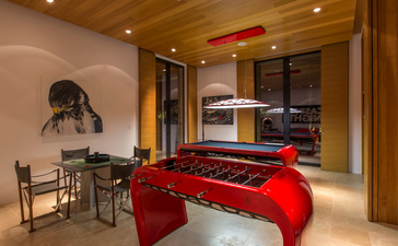 Villa 20 bedroom with red daybed and musical instruments at Amanzoe resort, Greece.