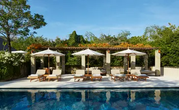 Six-bedroom villa with pool and pergola-shaded lounging areas at Aman Villas at Nusa Dua.