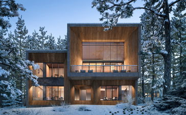 Aman Niseko villa exterior at dusk, illuminated wooden facade amongst snow-covered evergreens.