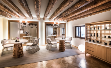 Aman Venice wellness centre interior with wooden beams, bathing areas and spa facilities.