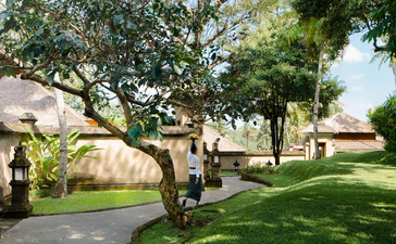 Amandari's wellness grounds with mature trees, manicured lawns and traditional architecture.