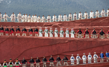Rows of white prayer flags strung across red-walled monastery courtyards at Amandayan.