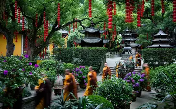 Lush garden courtyard at Amanfayun with traditional pagodas and lanterns amongst verdant vegetation.