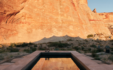 View of desert landscape framed through an open-air bathtub at Amangiri.