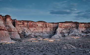 Desert landscape at Amangiri with layered red rock formations under a clear blue sky.