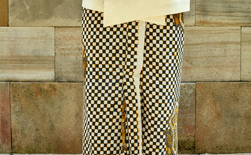 Person wearing a terracotta shirt and geometric patterned trousers at Amanjiwo resort.