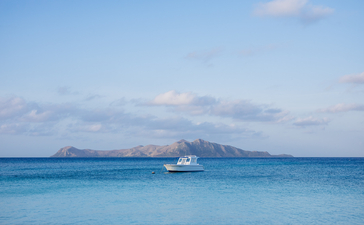 Sailing yacht anchored in turquoise waters at Amanpulo, Philippines.