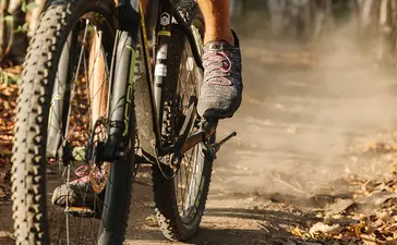Mountain biker on dusty trail at Amanwana, Indonesia.