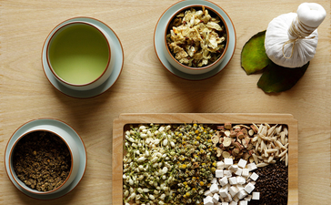 Amanyangyun tea ceremony arrangement with matcha, whisks, and traditional vessels on wooden surface.