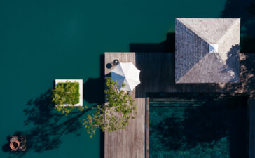 Aerial view of Amanyara's wellness facilities with wooden jetties extending into turquoise waters.