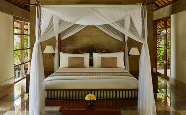 Principal bedroom with four-poster bed and wooden ceiling at Aman Villas at Nusa Dua.