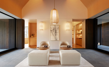 Amanemu wellness sanctuary with minimalist interior, warm lighting, and serene spa ambiance.