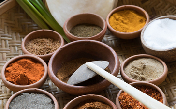 Overhead view of various spices and seasonings arranged in small bowls at Amanwella.