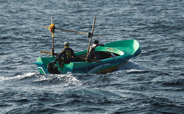 Traditional fishing boat on calm waters at Amanwella.