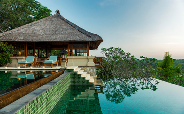 Three-bedroom villa at Amandari with infinity pool overlooking terraced gardens at dusk.