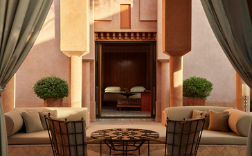 Al Hamra Maison lounge at Amanjena with fireplace and seating areas.