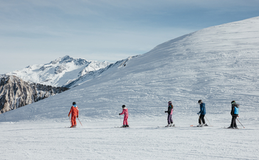 Guests enjoy a snowy mountain landscape at Aman Le Mélézin resort.