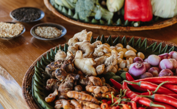 Ingredients and spices arranged on a wooden table at Aman Villas at Nusa Dua cooking class.