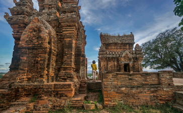 Ancient brick towers of Cham culture stand at Amanoi, Vietnam, against a blue sky.